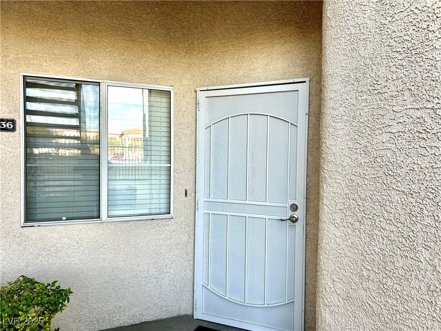 View of exterior entry with stucco siding