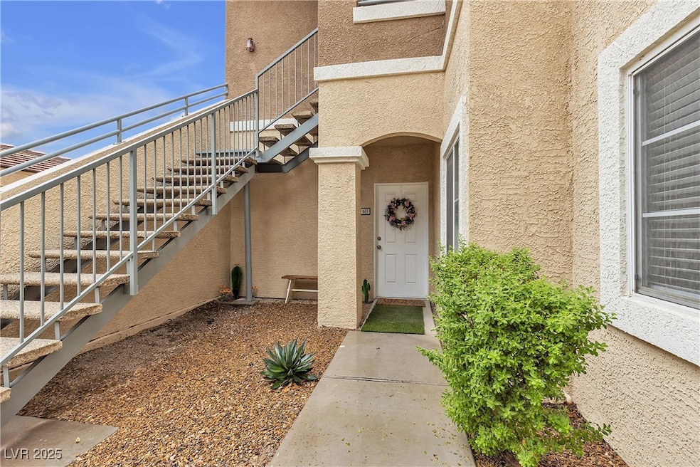Property entrance featuring stucco siding
