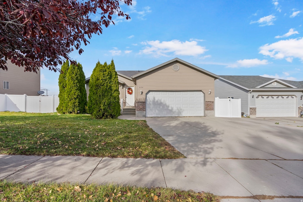 Ranch-style home featuring brick siding, driveway, and an attached garage