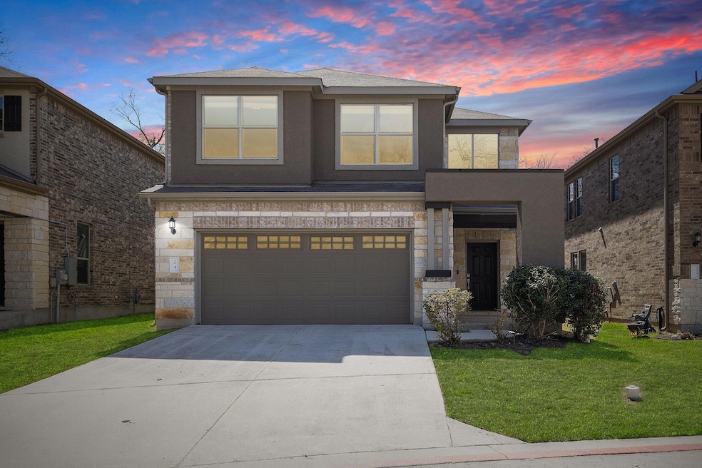 View of front facade featuring driveway, stucco s