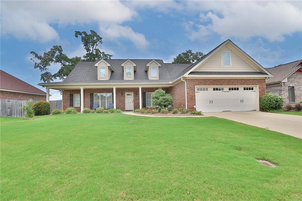 View of front of home with brick siding, driveway, and a garage