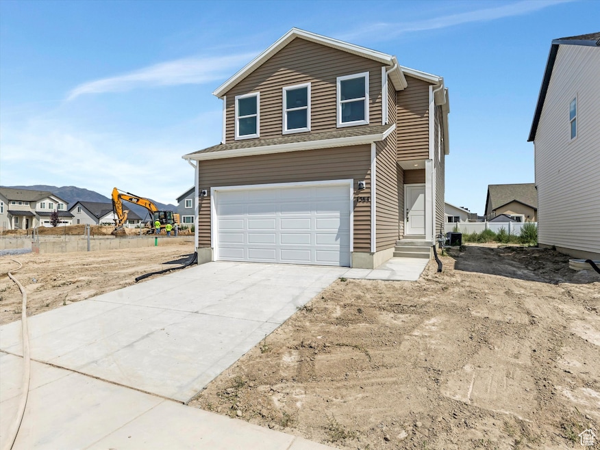 Traditional home with a residential view, concrete driveway, and an attached garage