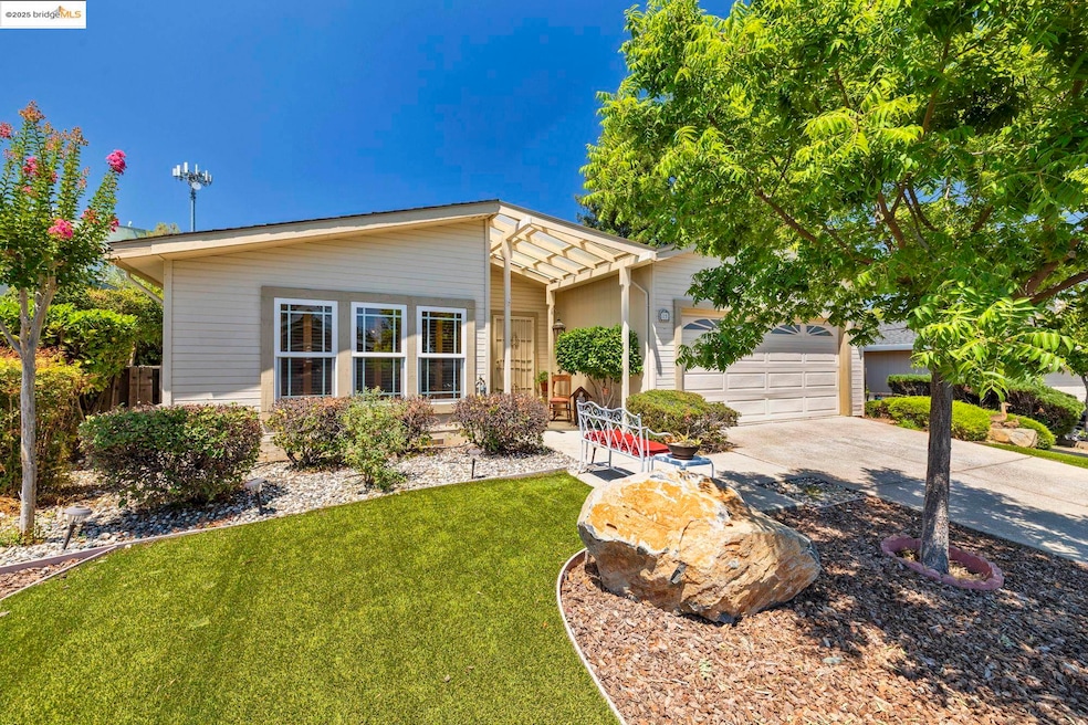 View of front of property with driveway, a garage, and a front lawn
