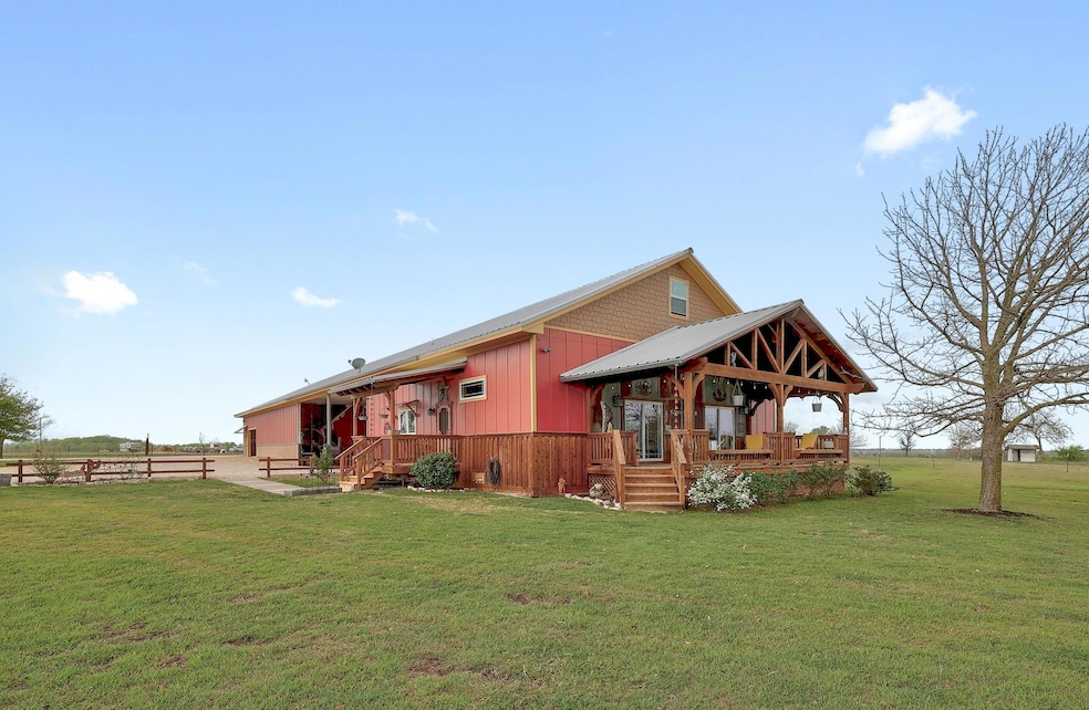 Back of property with a lawn