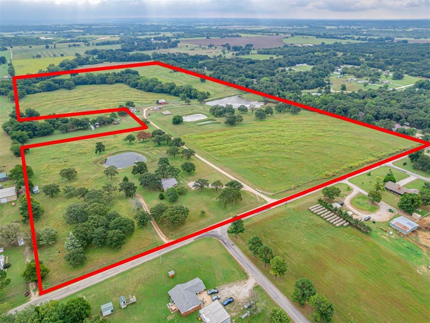 Aerial view of sparsely populated area featuring property boundaries highlighted