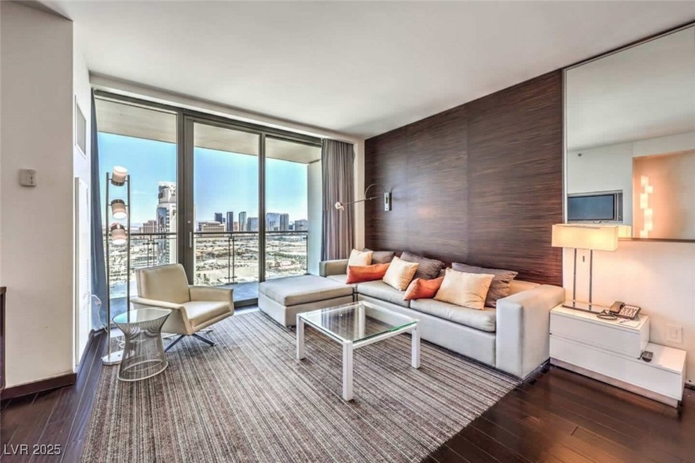Living room featuring expansive windows, baseboard