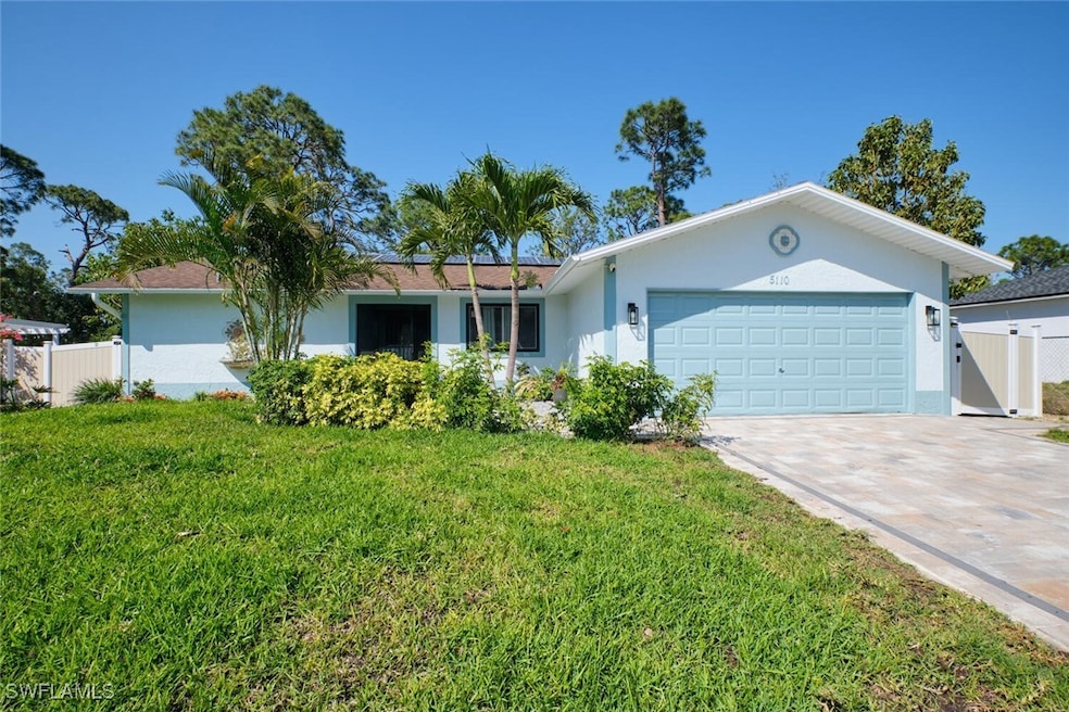 Ranch-style house featuring stucco siding, drivewa
