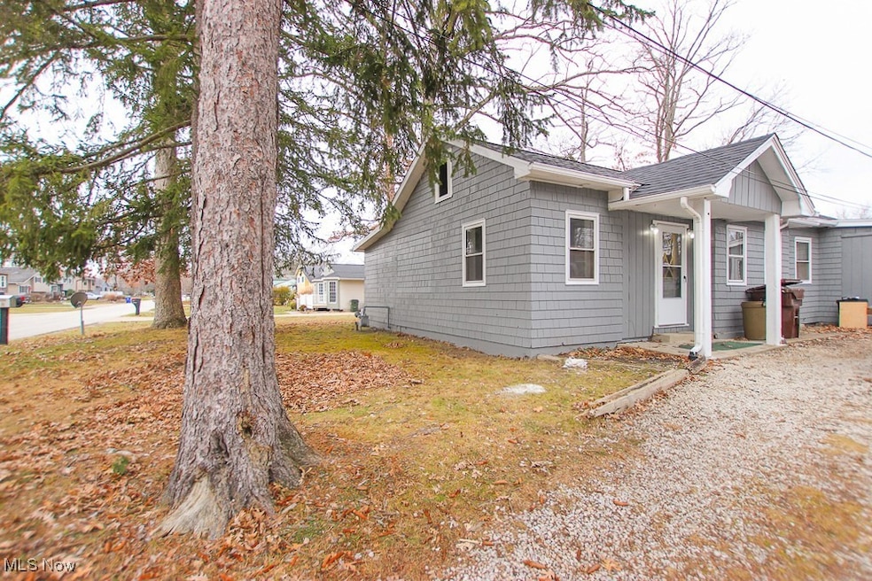 View of front of home with a patio area and a yard