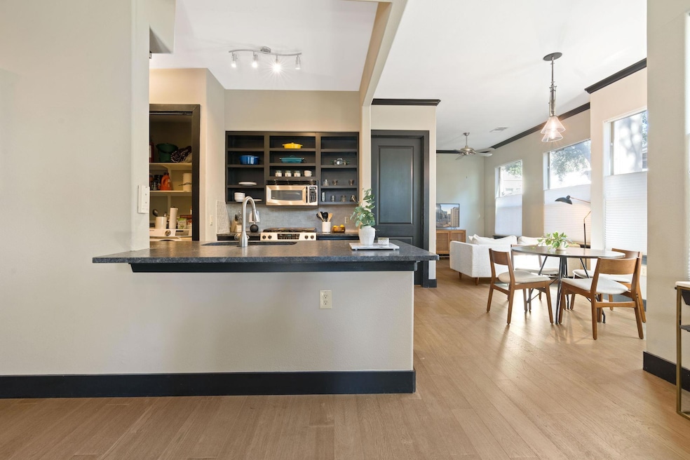 Kitchen featuring a ceiling fan, open shelves, a 
