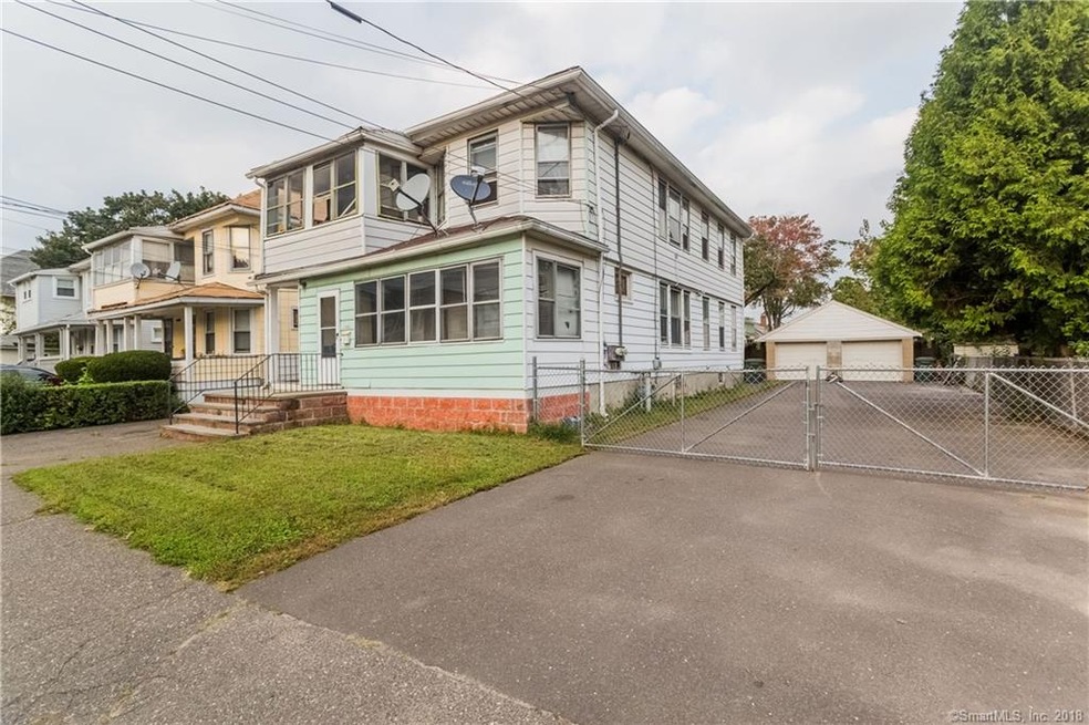 Front/right side of the house with fenced in long 