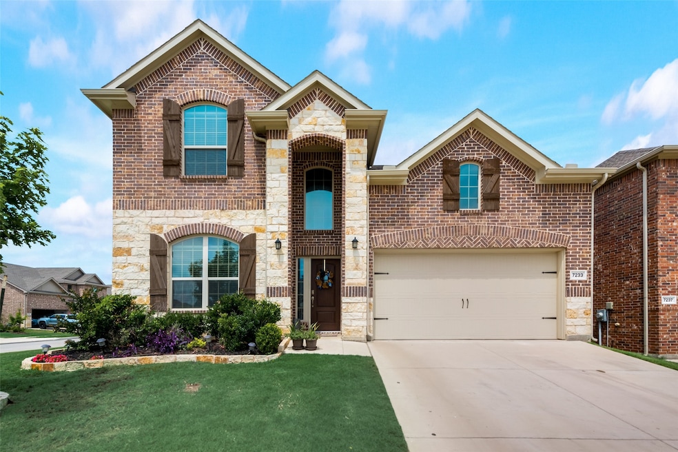 French country style house with stone siding, brick siding, and driveway