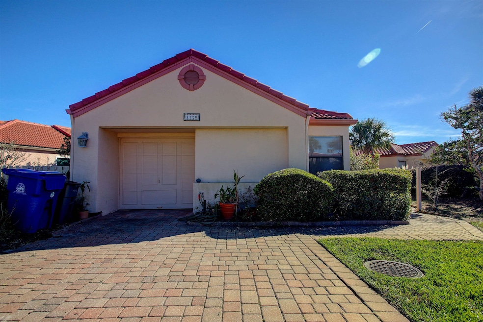 Mediterranean / spanish-style home with stucco siding, a garage, decorative driveway, and a tiled roof