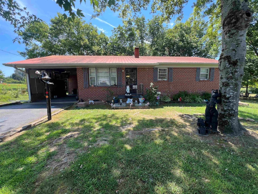 Ranch-style home with a carport and a front lawn