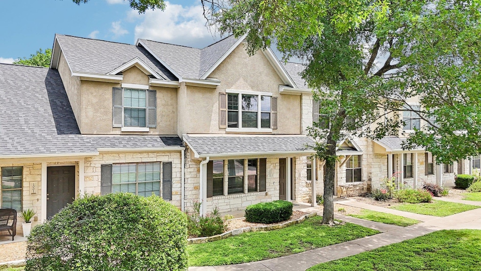 Townhome / multi-family property featuring stone 