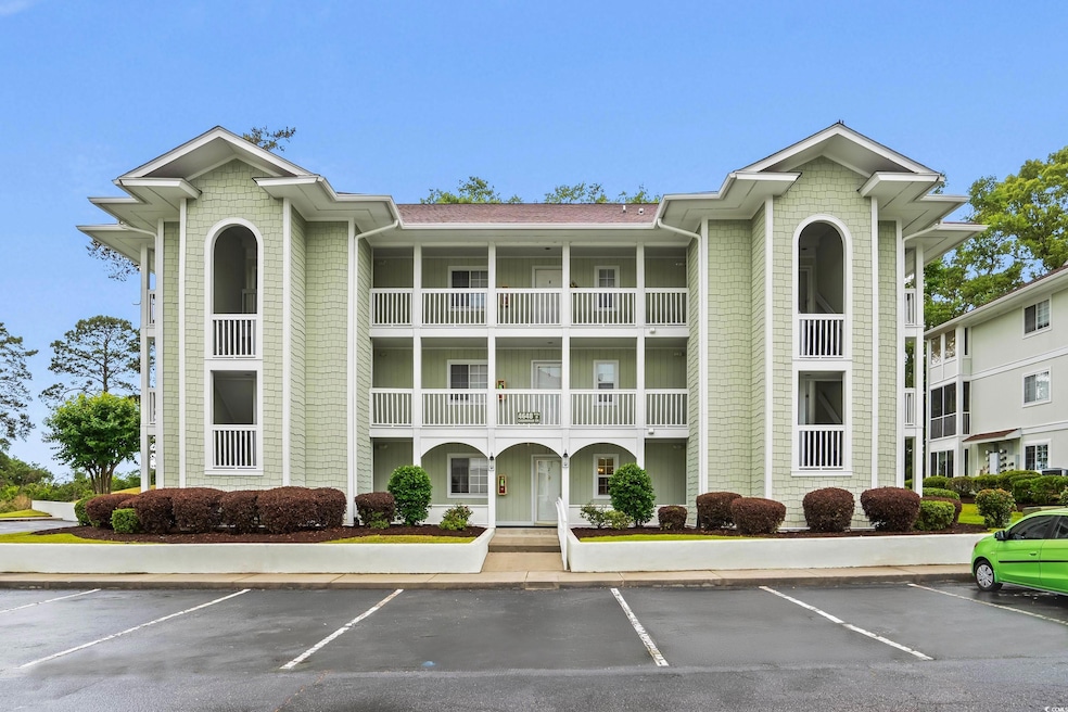 View of property featuring uncovered parking