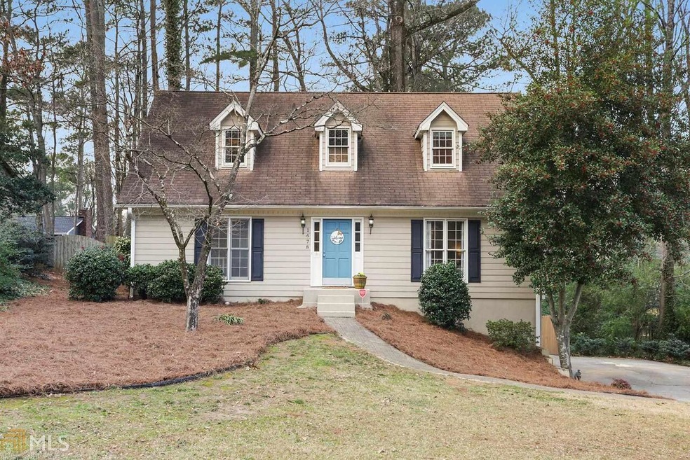 Welcoming Cape Cod home sits on quiet cul de sac.