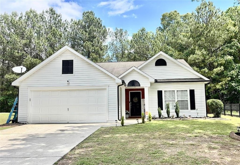 View of front facade with driveway and an attached