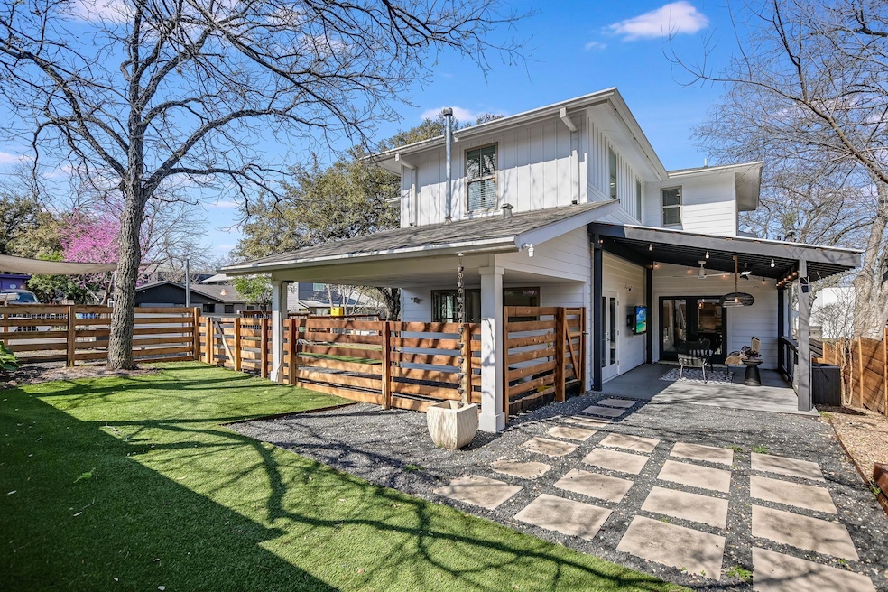 Rear view of house with a patio area, a yard, cei