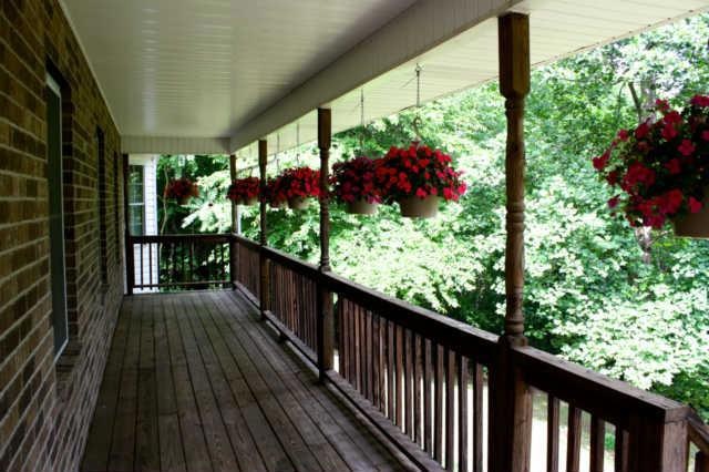 Relax on your covered front porch and feel the cool breeze amongst the trees!