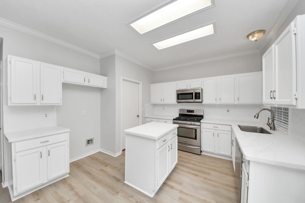 Gorgeous white kitchen with quartz countertops, su