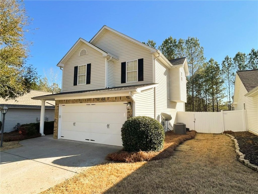 View of front facade featuring a garage and centra