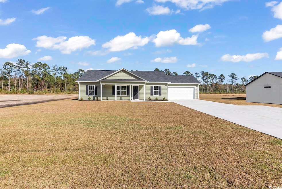 Single story home featuring covered porch, a garag
