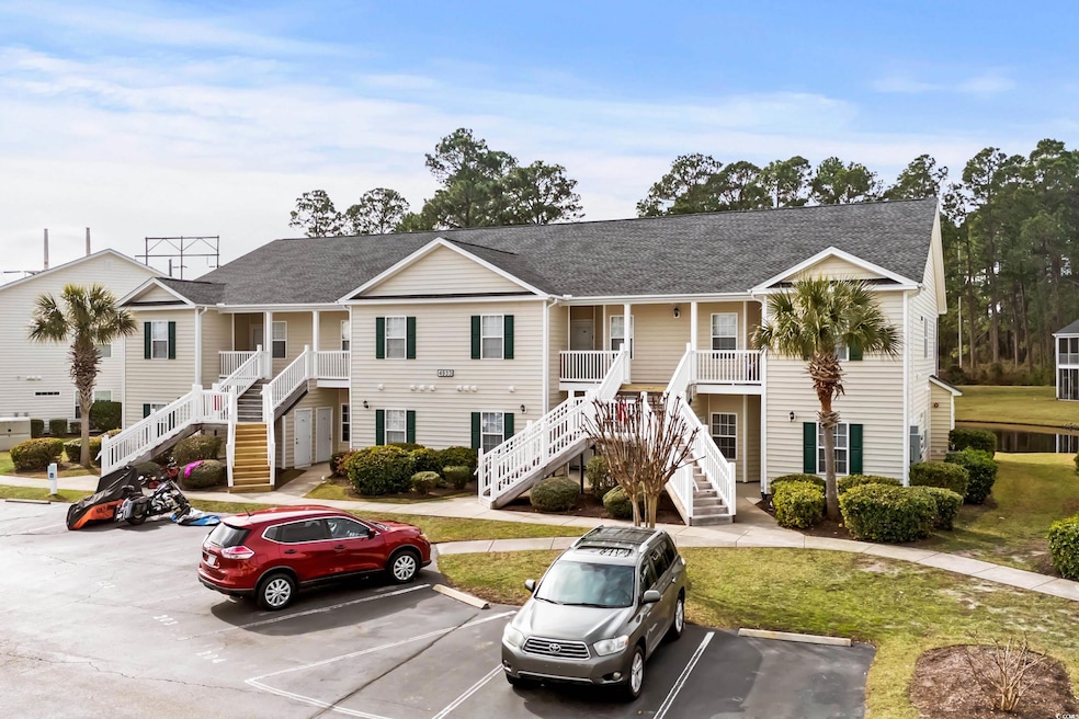 View of front of house with a porch and a front ya