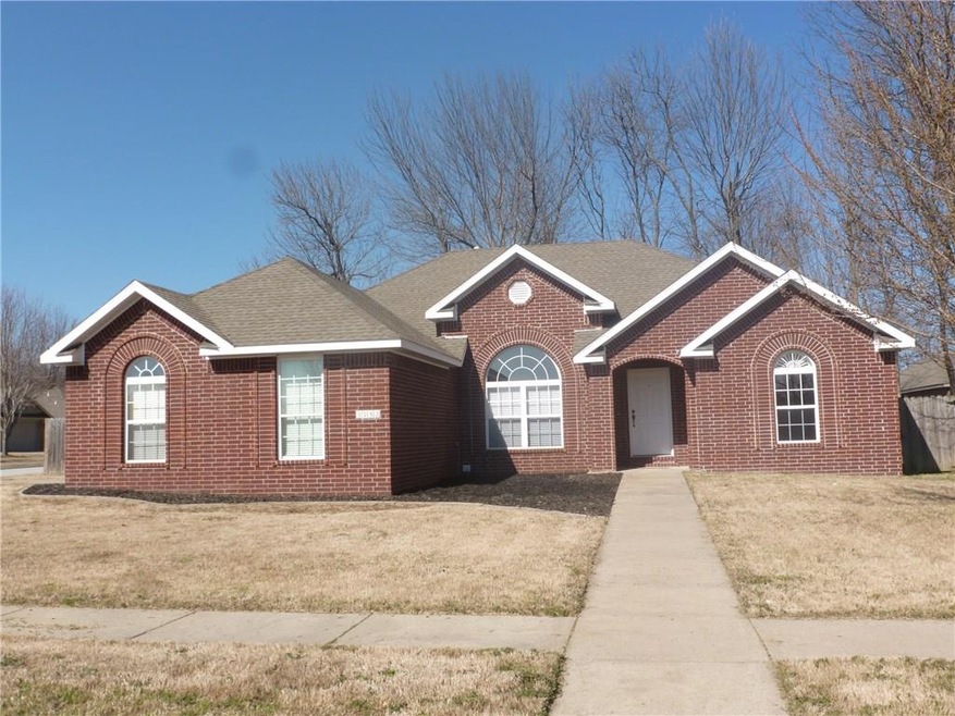 All brick home, covered front porch and freshly weeded and mulched flower beds ready for new shrubs.
