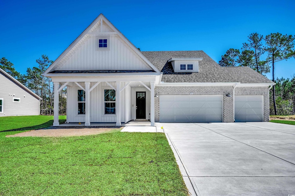 Modern inspired farmhouse featuring driveway, a front lawn, board and batten siding, roof with shingles, and an attached 3rd car garage. Grass color disclosure. Sod was just installed.