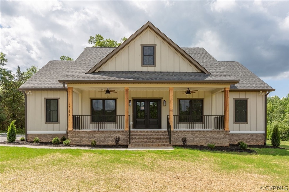 View of front of property with a front lawn, ceiling fan, and a porch
