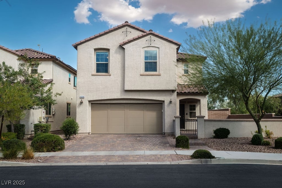 Mediterranean / spanish-style house with a gate, stucco siding, decorative driveway, and a tiled roof