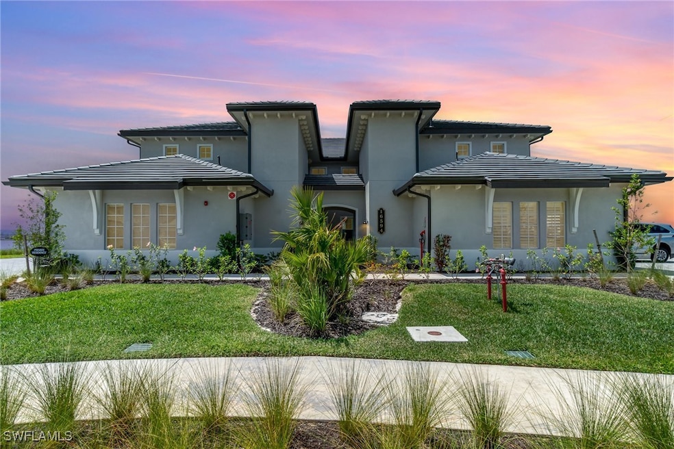 View of front of home featuring stucco siding, a f