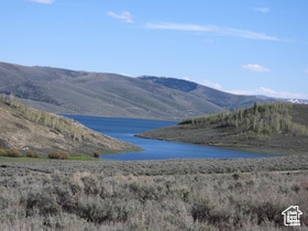 Property view of mountains featuring a water view