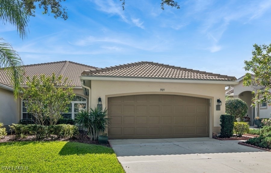 Mediterranean / spanish house with a garage and a