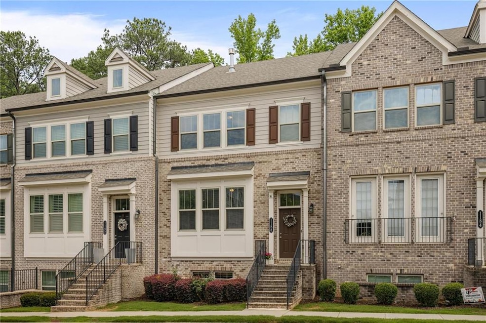 Townhome / multi-family property featuring brick siding