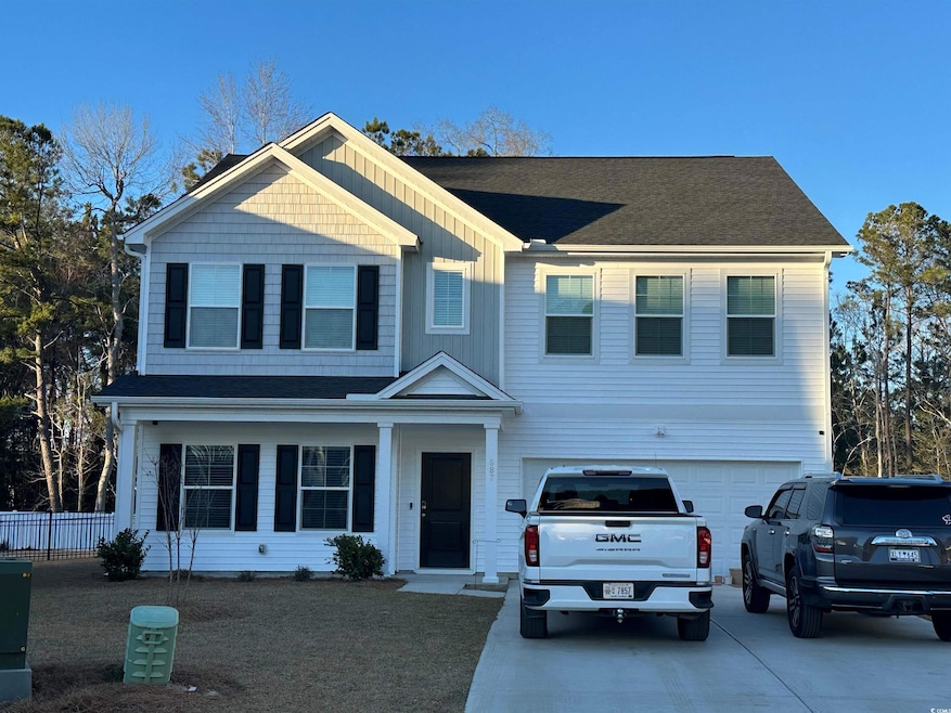 View of front of house featuring a garage, a shing