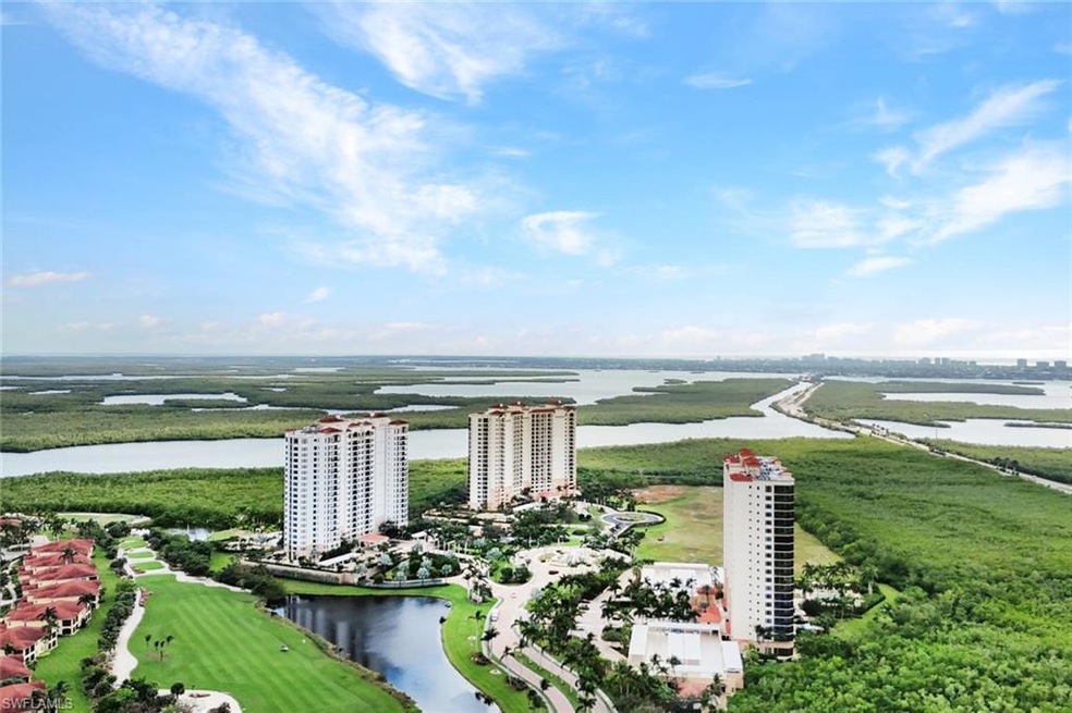 Drone / aerial view with golf course view and a wa