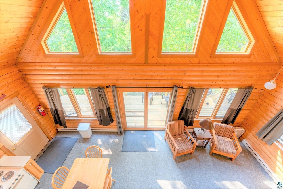 Living room with high vaulted ceiling and a wealth