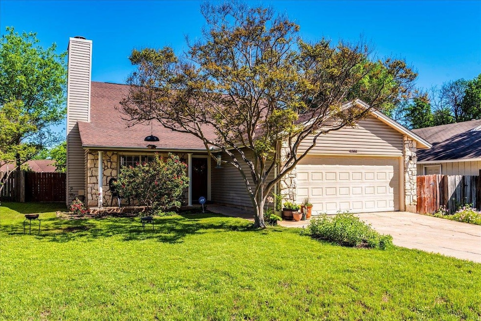 View of front facade featuring stone siding, a ga