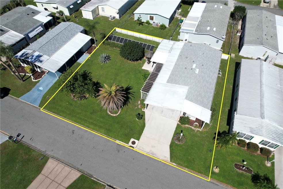 Aerial view of home with double lot and solar panels