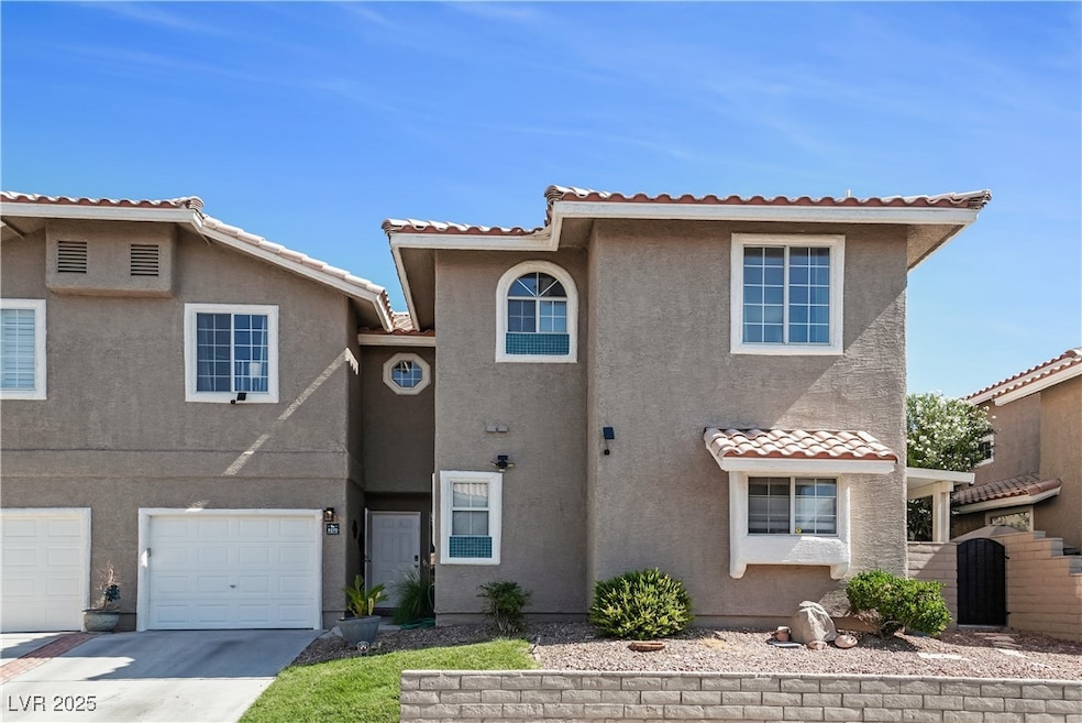 View of front of home with stucco siding, a tiled
