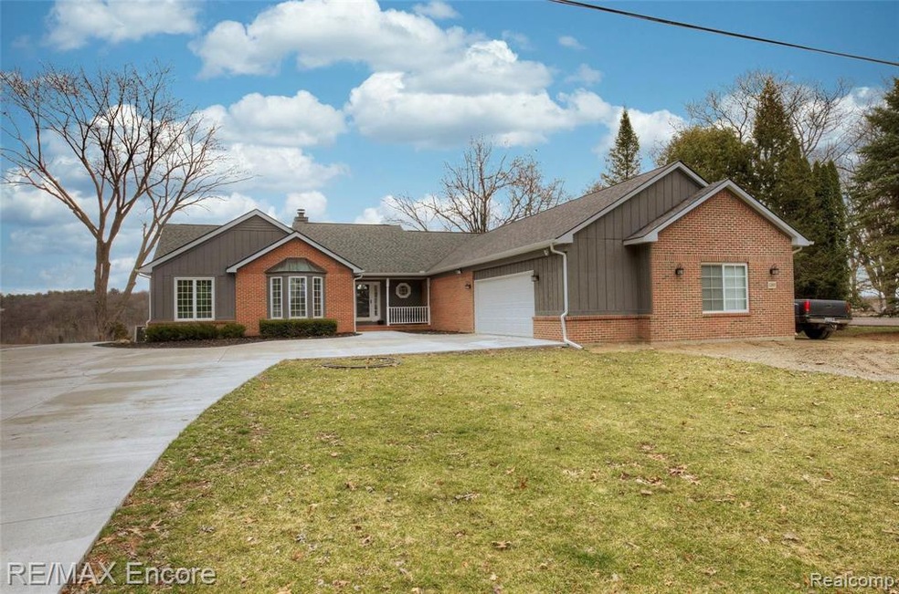 All Sports Lake front ranch home on 1.59 acres with 5 Car garage and a finished walk out basement in Milford Schools!!