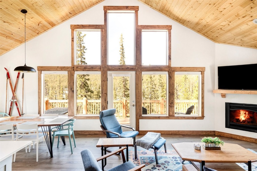 Living room featuring wooden ceiling, high vaulted