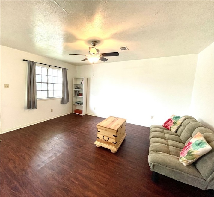 Living area featuring dark wood-type flooring, a c