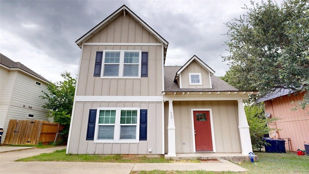 Craftsman-style home featuring board and batten siding and a shingled roof