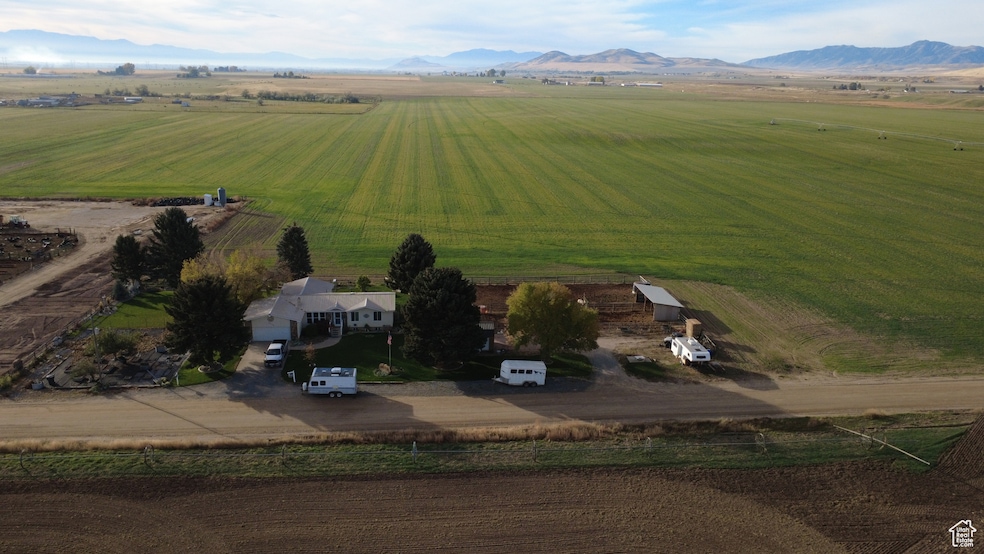 View of rural area featuring a mountain backdrop and extensive farmland