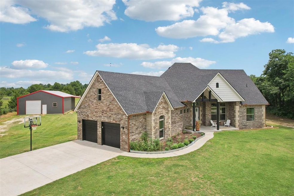 View of front facade featuring a garage and a fron