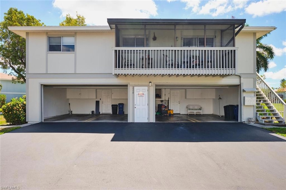 View of front of property with stairway, driveway, and a garage