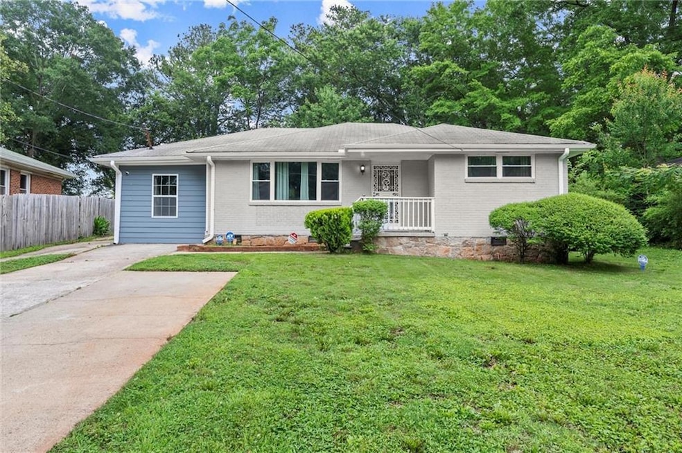 View of front of property with driveway and brick siding