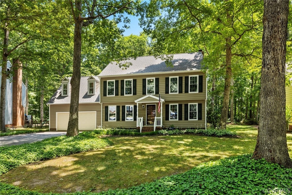 Colonial inspired home with a garage and a front l